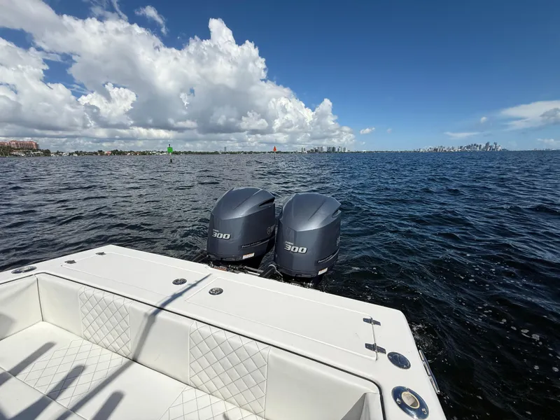 Slide: The Image of 2021 Avance 33 Cabriolet boat with twin 300 horsepower engines on open water. - 12