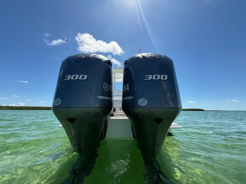 Slide: The Image of Twin Yamaha 300 engines on a 2021 Avance 33 Cabriolet in clear waters. - 5