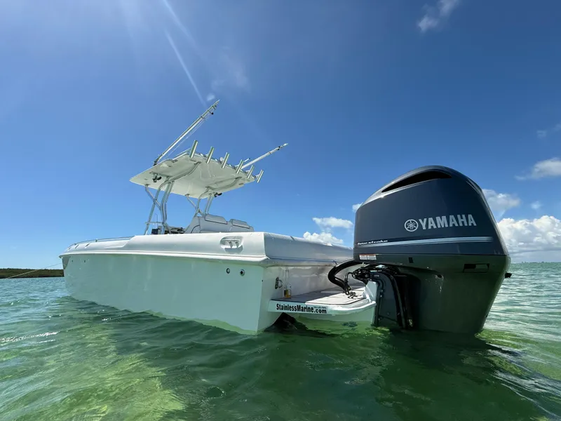 Slide: The Image of 2021 Avance 33 Cabriolet boat with Yamaha engine in clear water under blue sky. - 7