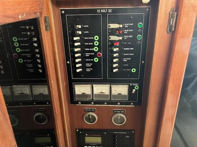 Slide: The Image of Electrical control panel on a 1983 Viking Convertible boat, featuring switches and gauges. - 12