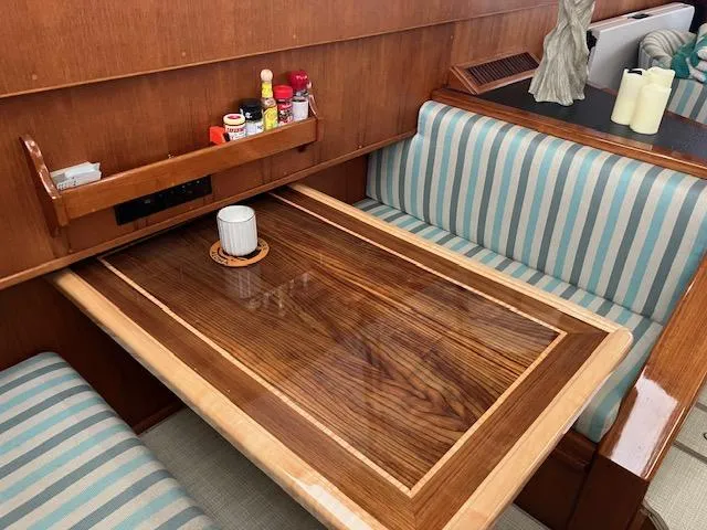Slide: The Image of 1983 Viking Convertible interior with wood table, striped seating, and condiment shelf. - 13