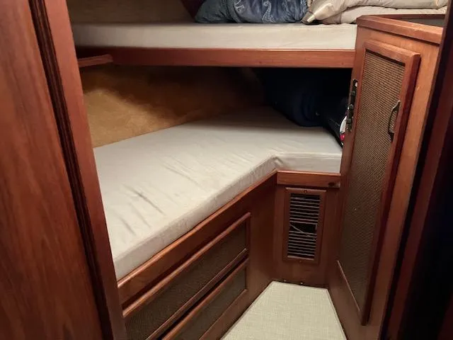 Slide: The Image of 1983 Viking Convertible boat cabin with wooden interior and bunk beds. - 15