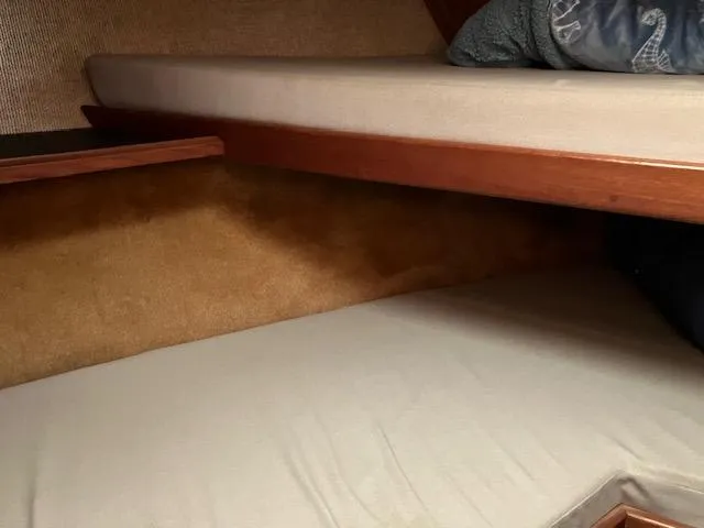 Slide: The Image of Interior cabin of a 1983 Viking Convertible boat with bunk beds. - 16