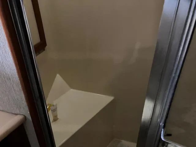 Slide: The Image of 1983 Viking Convertible yacht bathroom with shower and corner shelf. - 26