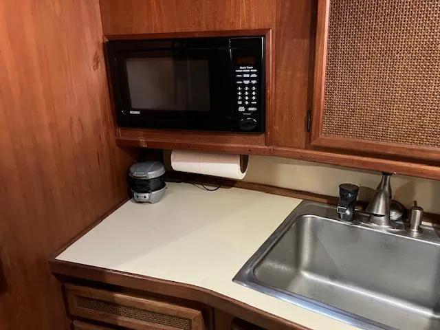 Slide: The Image of 1983 Viking Convertible kitchen with microwave, sink, and wooden cabinetry. - 29