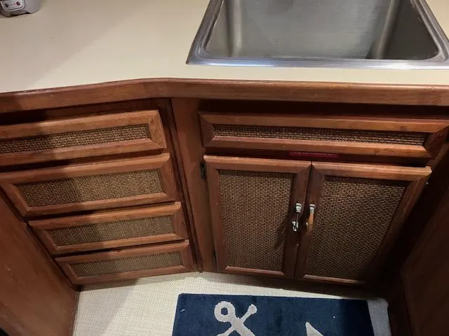 Slide: The Image of 1983 Viking Convertible kitchen with wooden cabinets and stainless steel sink. - 30