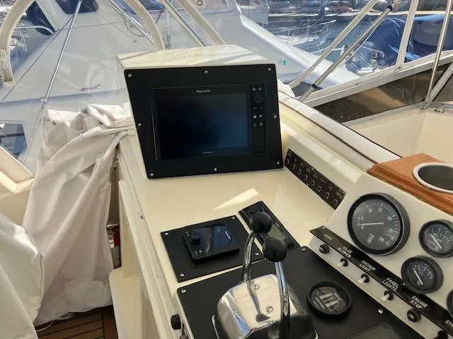 Slide: The Image of 1983 Viking Convertible boat dashboard with navigation equipment and control panel. - 36