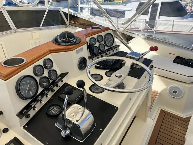 Slide: The Image of 1983 Viking Convertible yacht helm with steering wheel, gauges, and controls. - 37