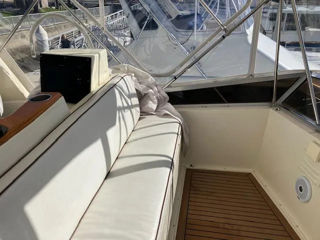 Slide: The Image of 1983 Viking Convertible boat interior with white seating and wooden flooring. - 39