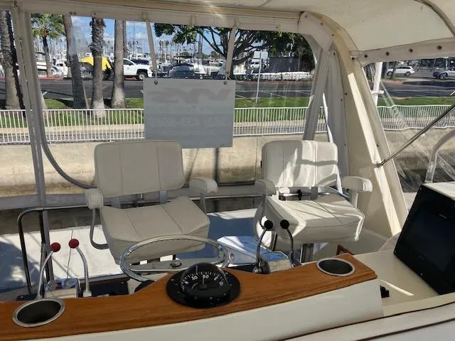 Slide: The Image of 1983 Viking Convertible boat cockpit with white seats, steering wheel, and control panel. - 41