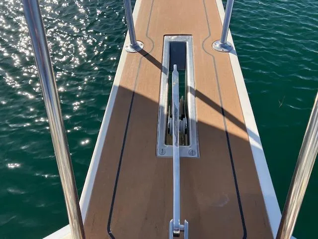 Slide: The Image of Bow of 1983 Viking Convertible yacht with anchor, over sparkling water. - 46