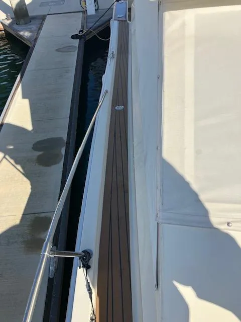Slide: The Image of 1983 Viking Convertible yacht with wooden deck detail at marina. - 48