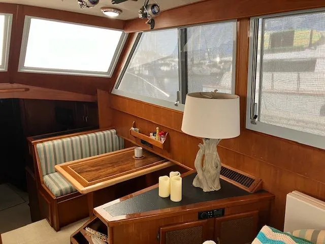 Slide: The Image of Interior of a 1983 Viking Convertible boat with wood paneling and cozy seating area. - 6