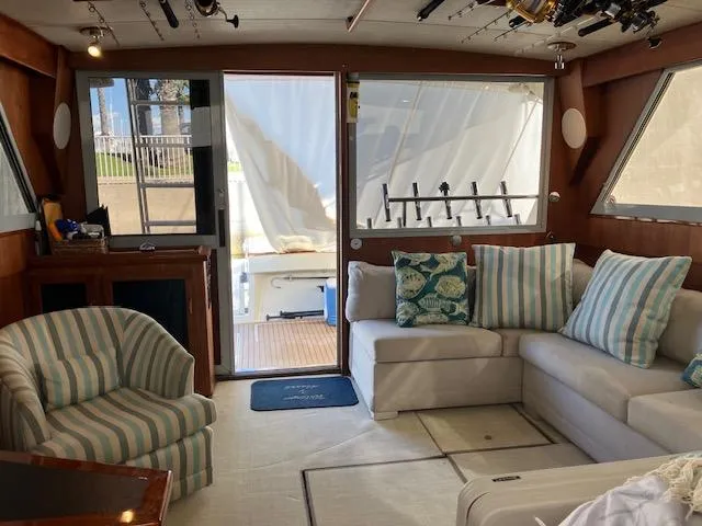 Slide: The Image of Interior of a 1983 Viking Convertible yacht with cozy seating and nautical decor. - 7