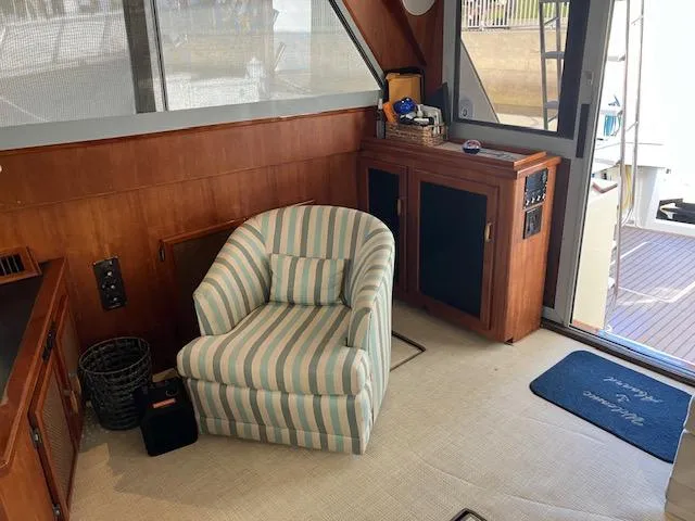 Slide: The Image of 1983 Viking Convertible interior with striped chair and wooden cabinetry. - 9