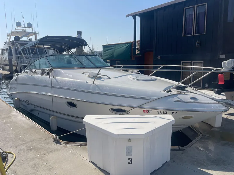 The Image of 2003 Larson 270 boat docked at marina, featuring sleek design and spacious deck. - 0