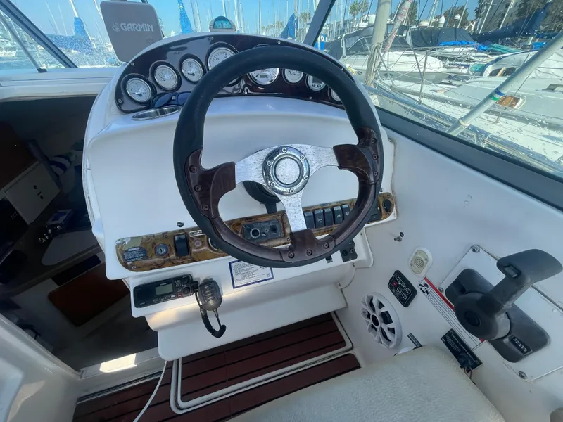 Slide: The Image of 2003 Larson 270 boat cockpit with steering wheel and control panel. - 13