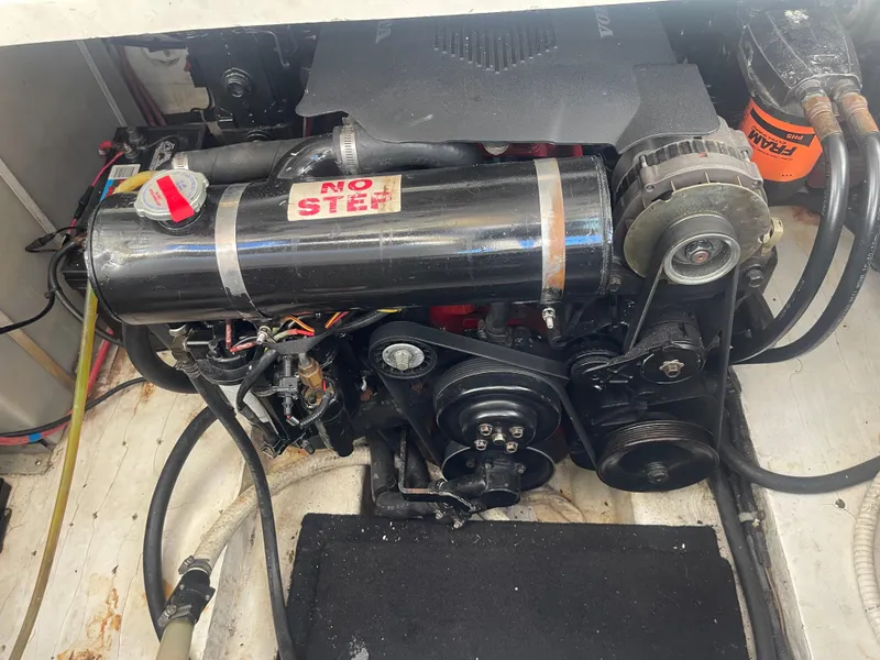 Slide: The Image of Engine compartment of a 2003 Larson 270 boat, featuring visible components and wiring. - 16