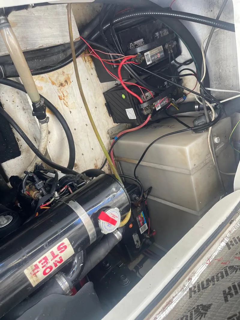 Slide: The Image of Engine compartment of a 2003 Larson 270 boat, showing wiring and components. - 17