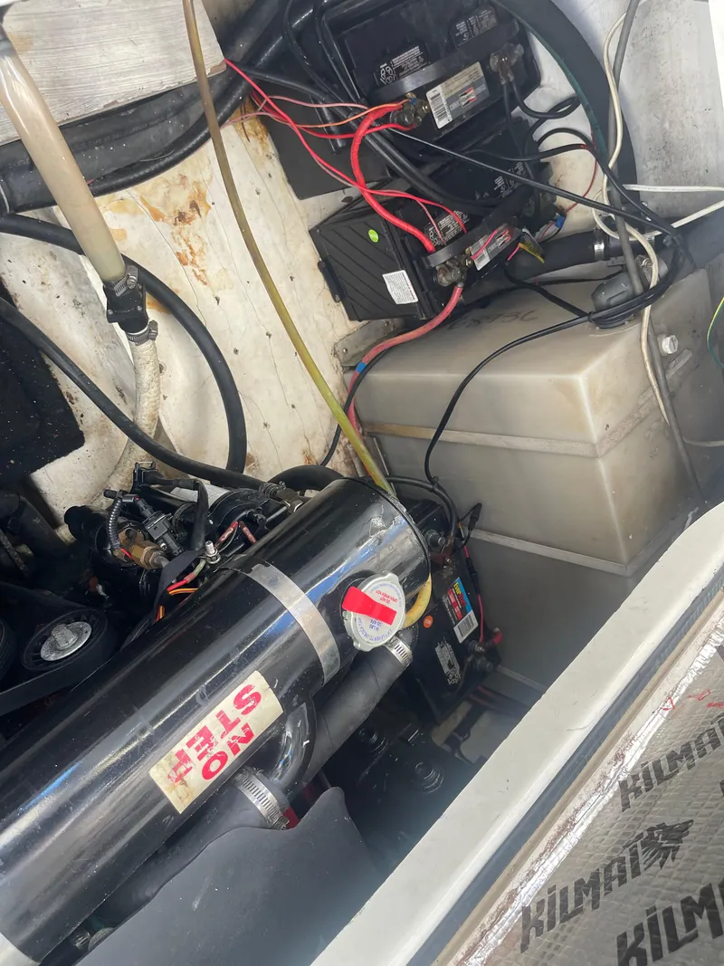 Slide: The Image of Engine compartment of a 2003 Larson 270 boat, showing wiring and components. - 18