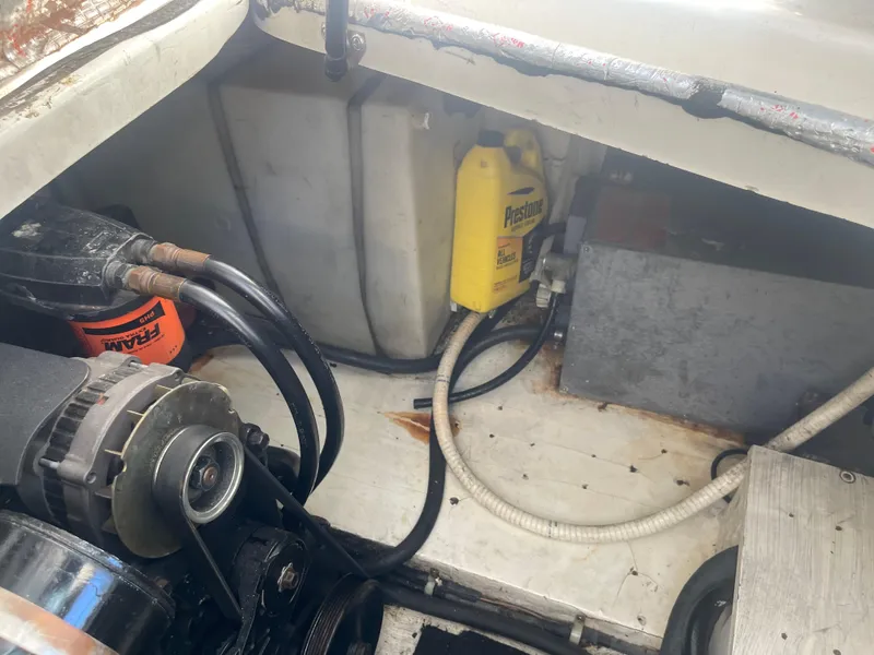 Slide: The Image of Engine compartment of a 2003 Larson 270 boat, showing components and storage. - 19