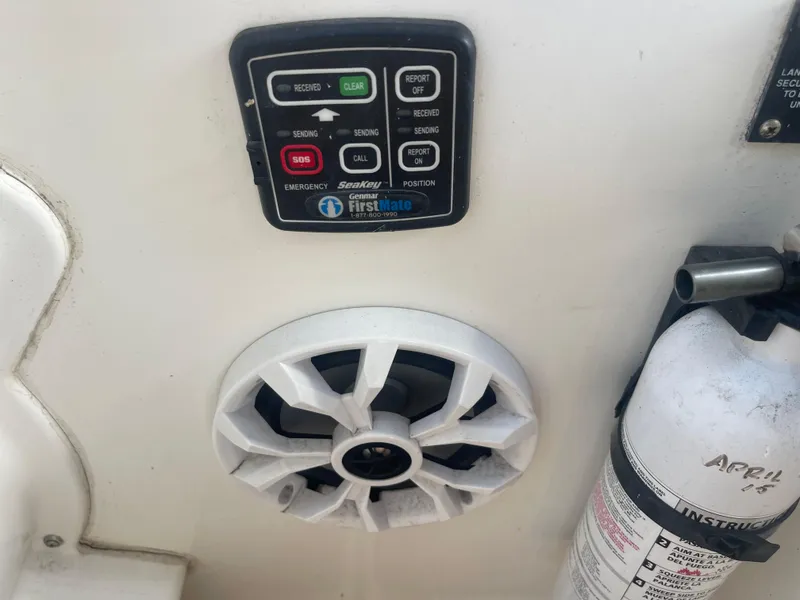 Slide: The Image of Control panel and speaker on a 2003 Larson 270 boat, with a fire extinguisher nearby. - 21