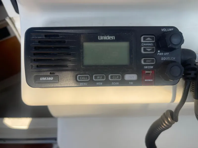 Slide: The Image of Uniden UM380 marine radio on a 2003 Larson 270 boat dashboard. - 23