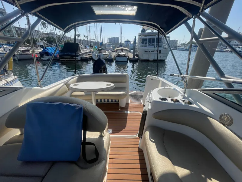 Slide: The Image of Interior view of a 2003 Larson 270 boat docked at a marina. - 4