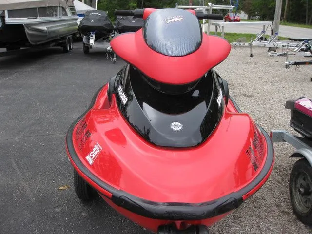 Slide: The Image of Red 2004 Sea-Doo XP® DI DI jet ski on parking lot. - 6