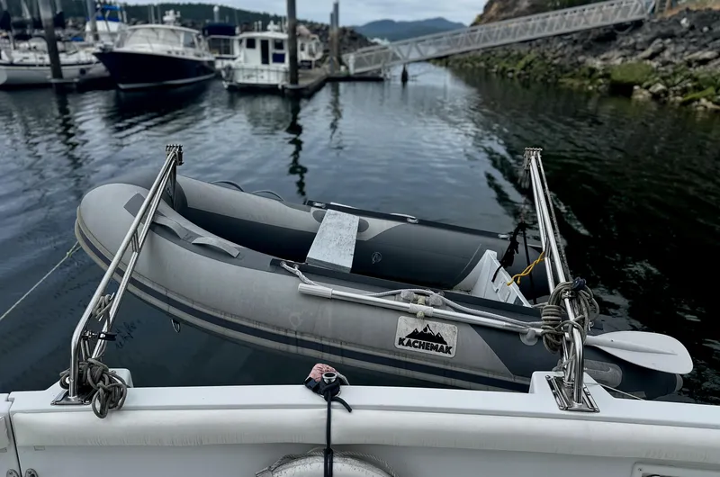 Slide: The Image of Inflatable boat on Carver 374 Voyager, 2000 model, docked in a marina. - 11