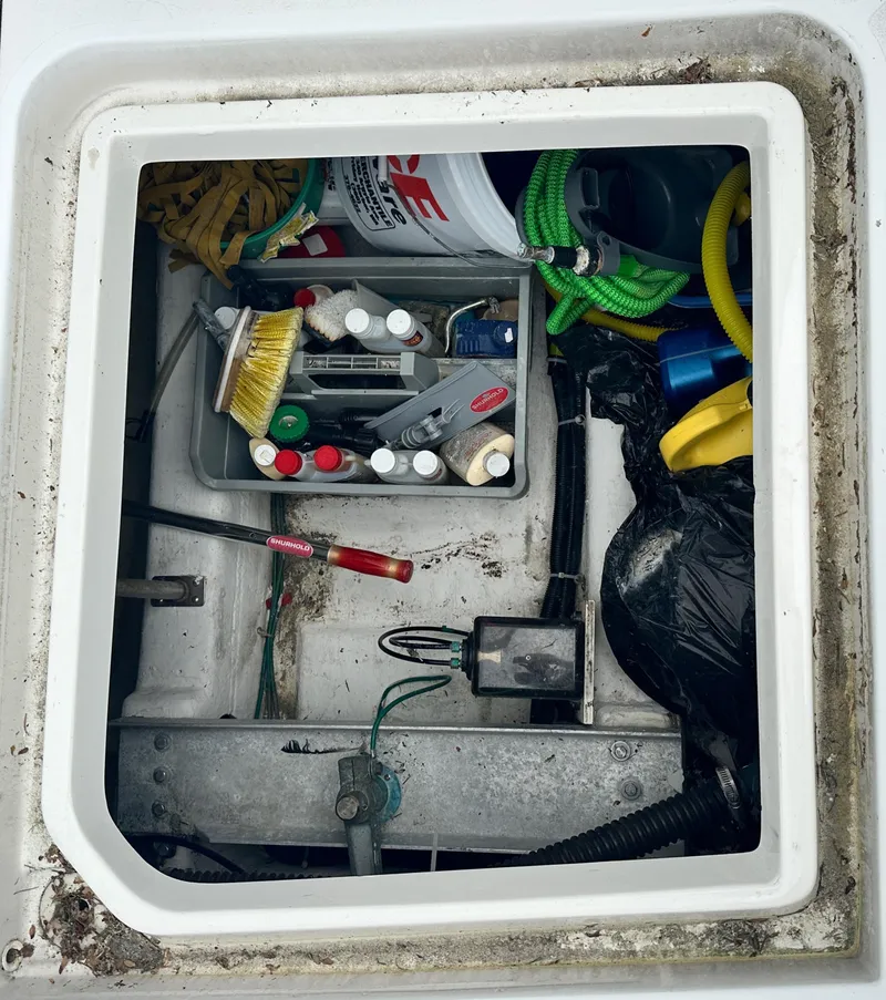 Slide: The Image of Storage compartment of a 2000 Carver 374 Voyager with cleaning supplies and tools. - 15