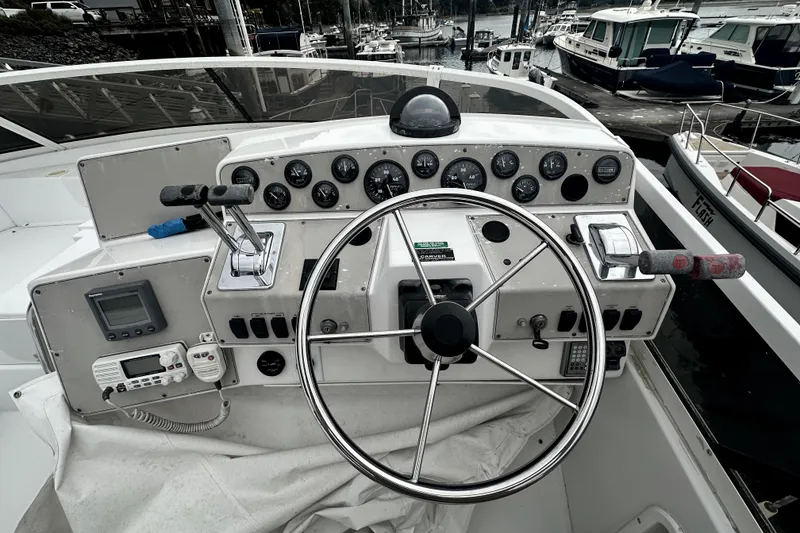 Slide: The Image of Helm of 2000 Carver 374 Voyager yacht with steering wheel and control panel. - 17