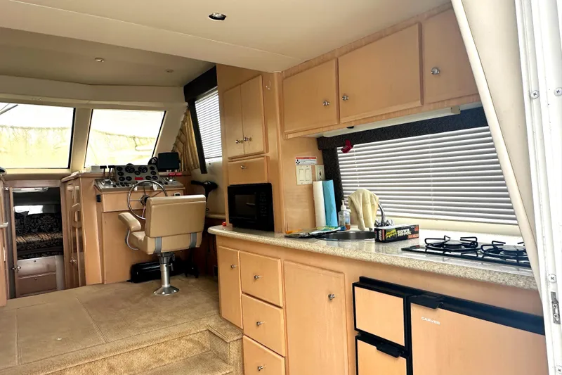 Slide: The Image of Interior of 2000 Carver 374 Voyager yacht with kitchen and helm station. - 28