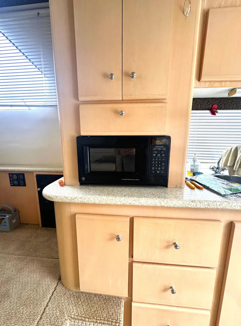 Slide: The Image of 2000 Carver 374 Voyager kitchen with microwave and wooden cabinetry. - 30