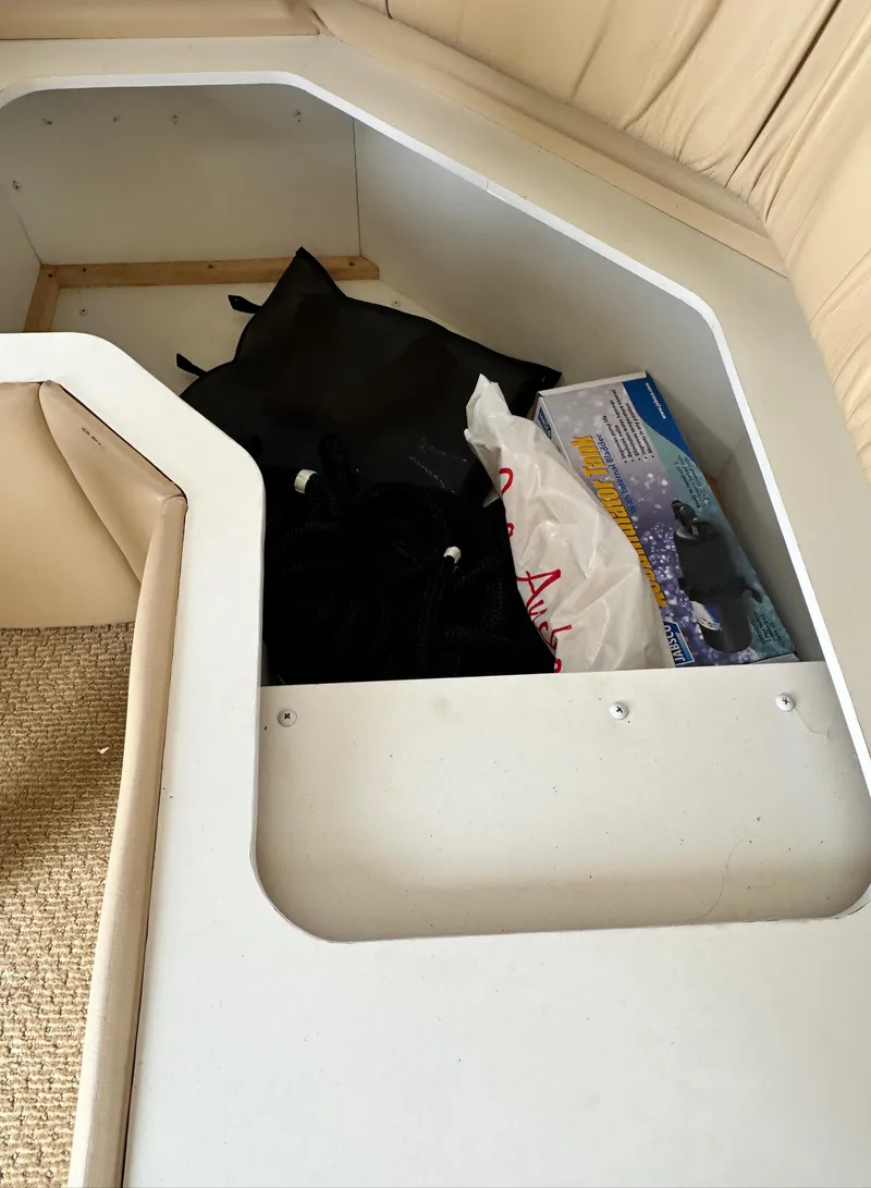 Slide: The Image of Storage compartment in a 2000 Carver 374 Voyager boat with various items inside. - 35