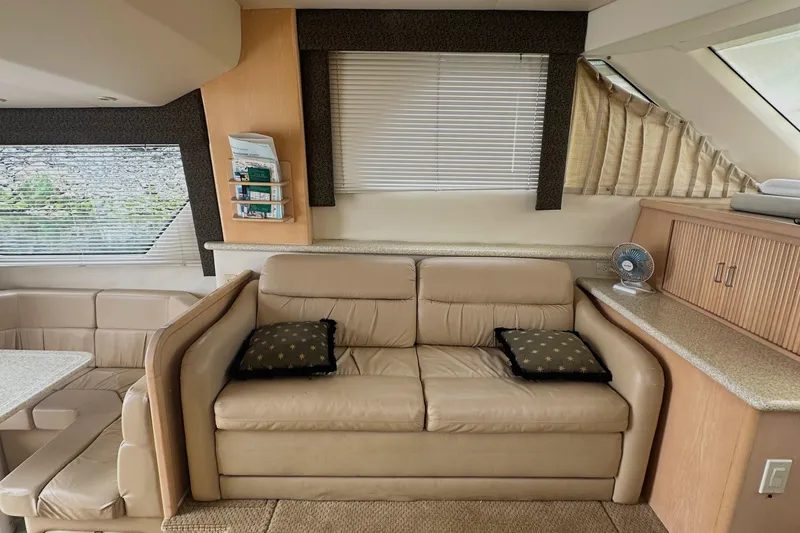 Slide: The Image of Interior of 2000 Carver 374 Voyager yacht with beige sofa and dining area. - 37