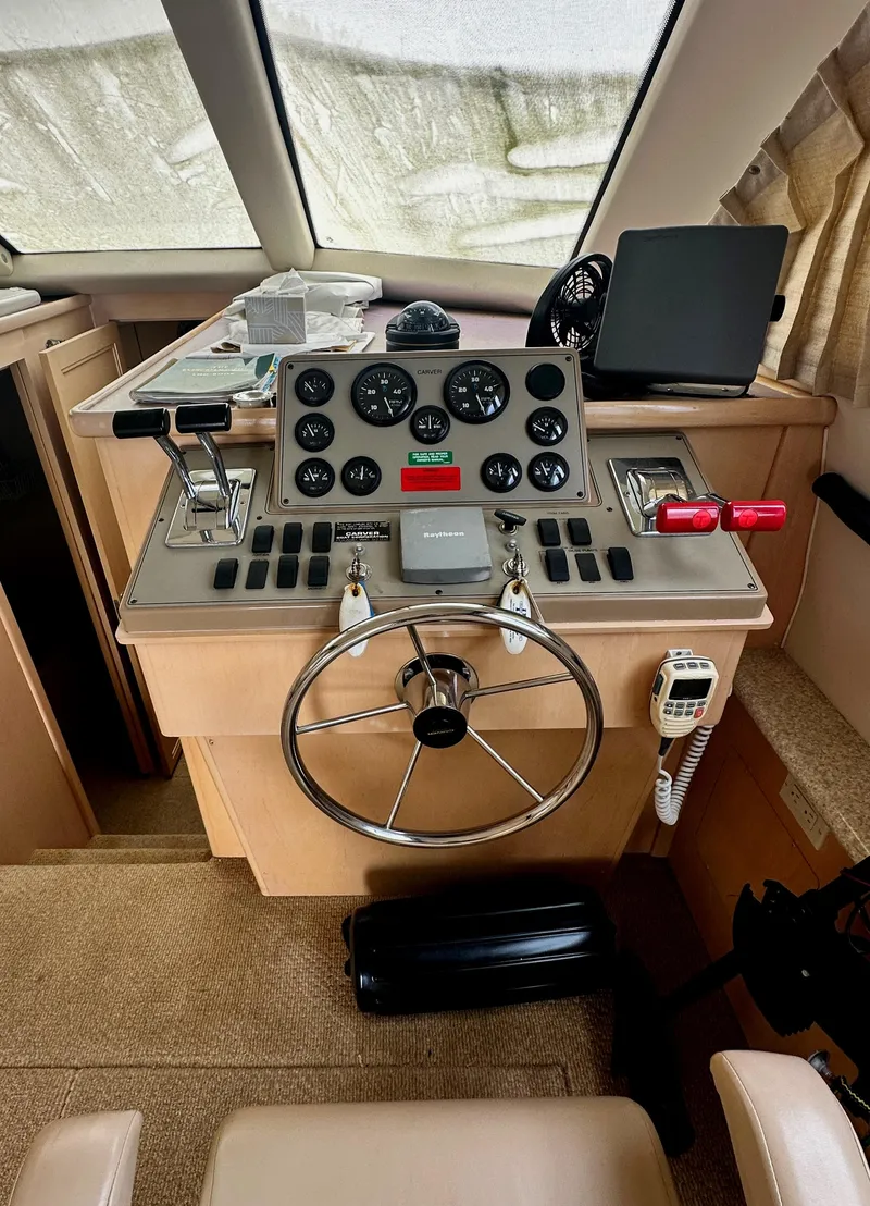 Slide: The Image of Control panel of a 2000 Carver 374 Voyager yacht with steering wheel and gauges. - 40