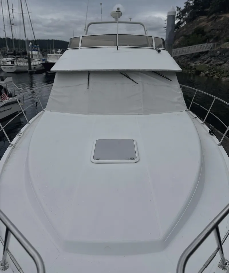 Slide: The Image of 2000 Carver 374 Voyager yacht docked in a marina, overcast sky. - 5