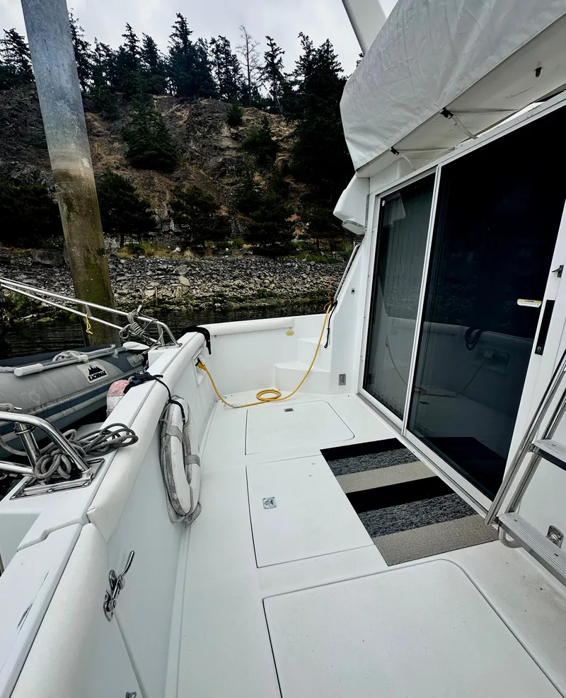 Slide: The Image of 2000 Carver 374 Voyager yacht deck with scenic forest backdrop. - 9