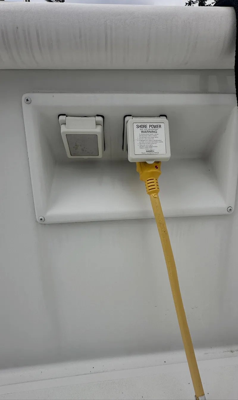Slide: The Image of Power outlet on 2000 Carver 374 Voyager boat with yellow cable connected. - 13