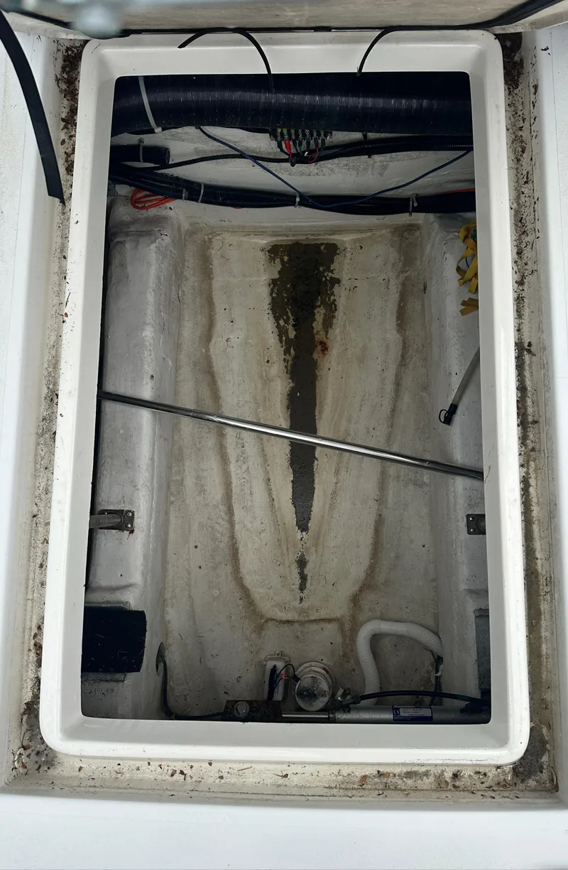 Slide: The Image of Engine compartment of a 2000 Carver 374 Voyager boat, showing interior details and components. - 14