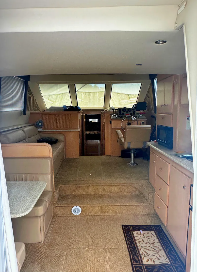 Slide: The Image of Interior of 2000 Carver 374 Voyager yacht with seating, helm, and cabinetry. - 25