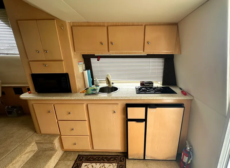 Slide: The Image of Compact kitchen in 2000 Carver 374 Voyager yacht with stove, sink, and mini-fridge. - 27