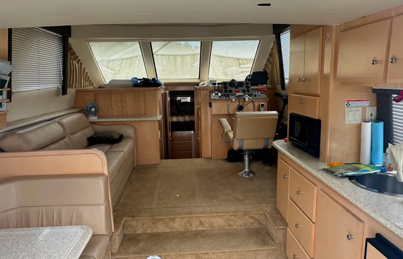 Slide: The Image of Interior of 2000 Carver 374 Voyager yacht with seating, helm, and kitchenette. - 29