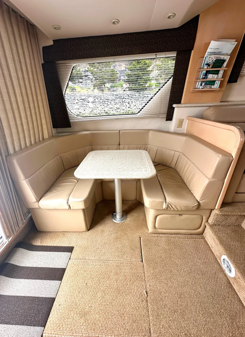 Slide: The Image of Interior of 2000 Carver 374 Voyager with beige seating and dining table. - 34