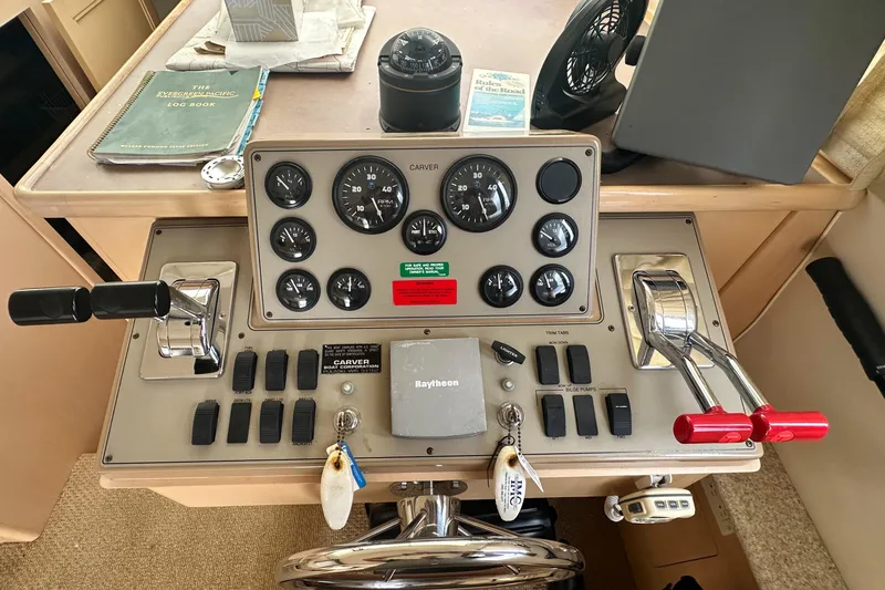 Slide: The Image of Control panel of a 2000 Carver 374 Voyager boat with gauges and levers. - 41