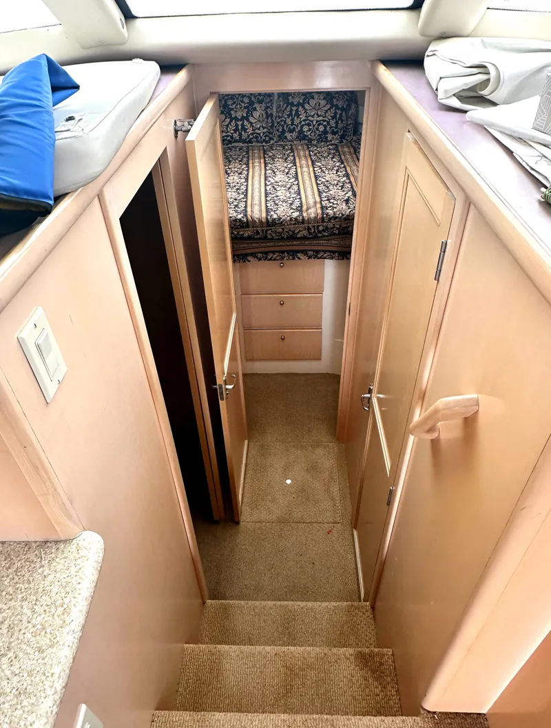 Slide: The Image of Interior of 2000 Carver 374 Voyager yacht, featuring stairs, doors, and a cozy cabin area. - 49