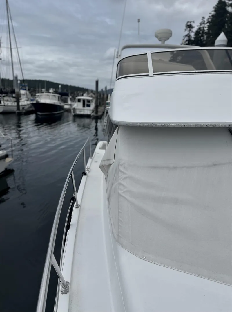 Slide: The Image of 2000 Carver 374 Voyager yacht docked at a marina, overcast sky. - 7