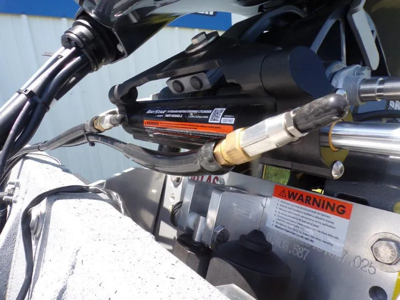 Slide: The Image of Close-up of 2026 Xpress SW20BAY boat engine components with warning labels. - 10