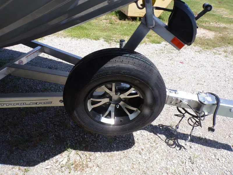 Slide: The Image of Trailer wheel of 2026 Xpress SW20BAY boat on gravel surface. - 12